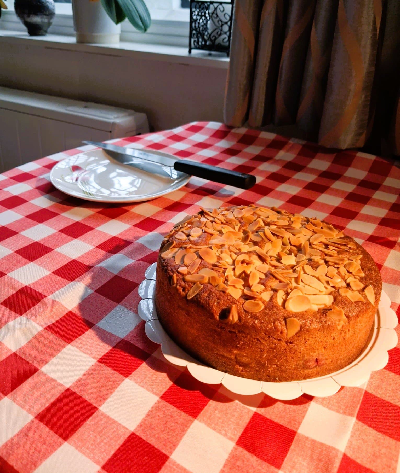 Dairy-free Bakewell cake topped with toasted flaked almonds, homemade by Farmhouse Cakes in Seaford