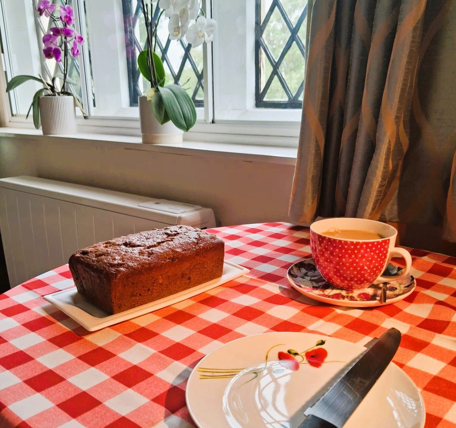 Homemade dairy-free date and walnut loaf cake with a cup of tea, baked by Farmhouse Cakes in Seaford