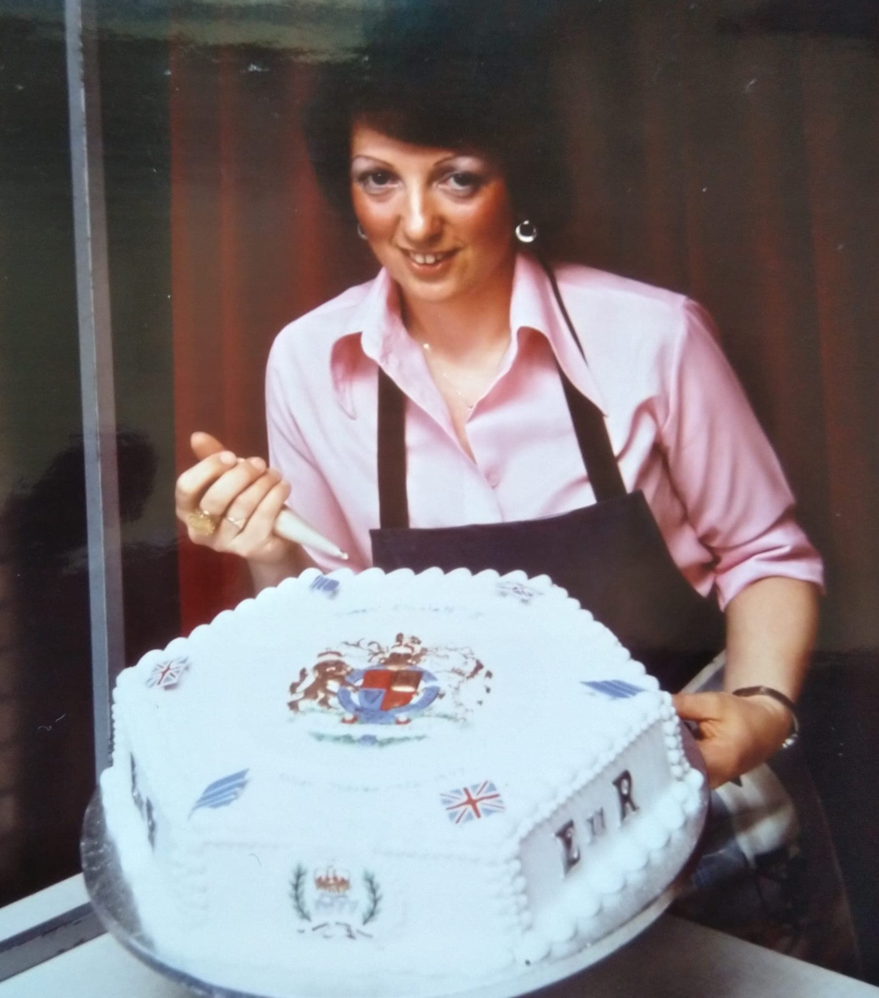 Christine piping icing onto the Silver Jubilee cake in 1977