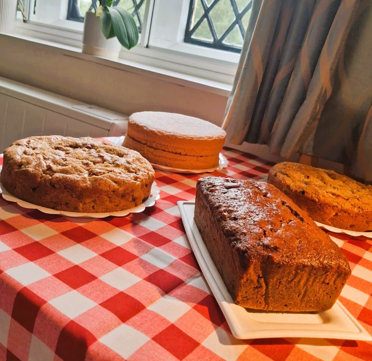 Homemade dairy-free cakes by Farmhouse Cakes, Seaford: two Dorset apple cakes, a Victoria sponge and a date and walnut loaf